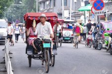 60797582-beijing-china-jul-03-2016-tourists-in-a-rickshaw-in-a-hutong-ancient-hutongs-are-form...jpg